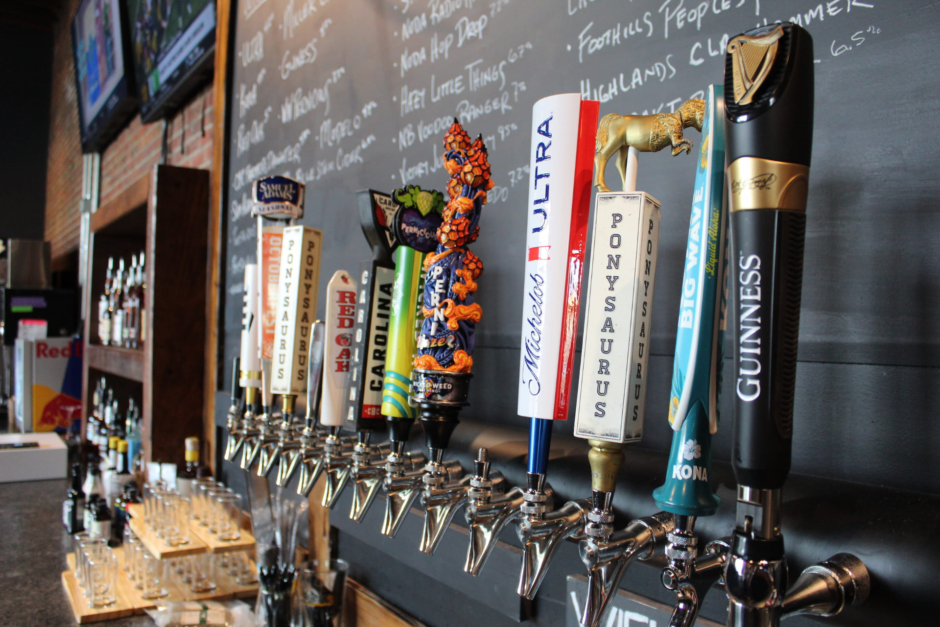 Tap wall and chalkboard beer menu at Prophecy Social House